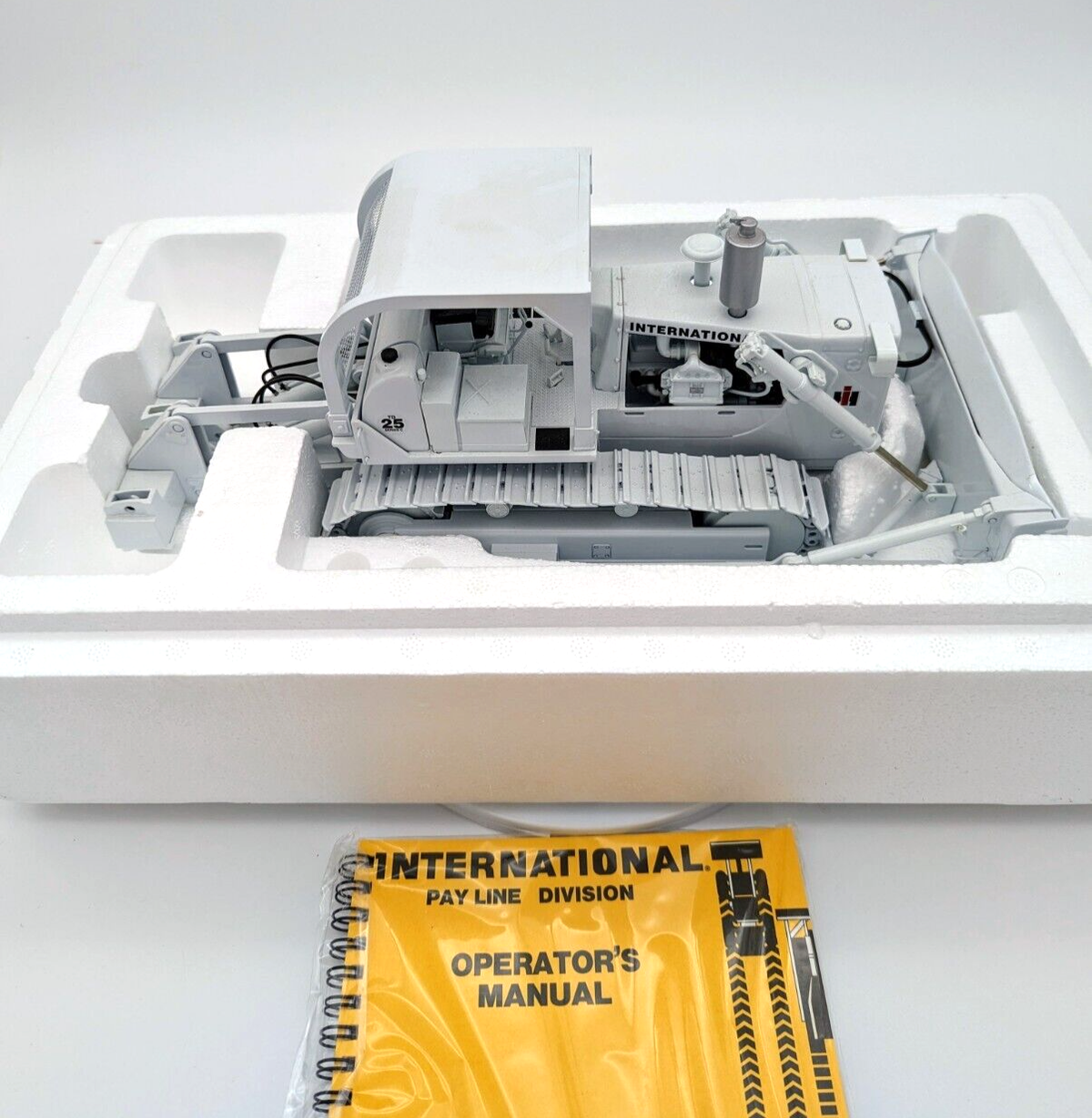 "Detailed model of 1/25 scale International White TD-25 Crawler perfect for hobbyists"